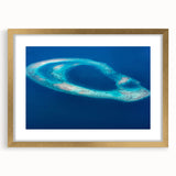 Extra large abstract art print of Maldivian scenery in muted blue and green tones on textured canvas, framed in gold.