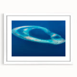 Abstract art print of Maldives scenery in muted blue and green, framed in white, ideal for bedroom or dining room decor.