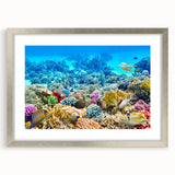 Abstract art print of the Great Barrier Reef in blue and aqua tones on a framed canvas.