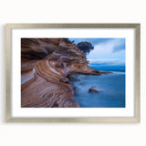 Abstract art print of Tasmania scenery in muted green and blue tones, framed in silver, ideal for dining room decor.