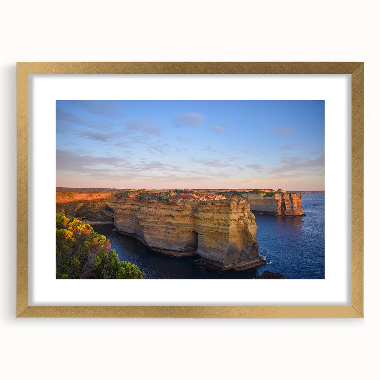 Abstract art print of Australian scenery in muted earth tones, framed in gold, suitable for dining room decor.