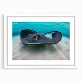 Textured abstract art print depicting Caribbean scenery in muted blue and green tones on a framed white mat.