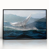 Large abstract wall art depicting a Caribbean scenery in muted blue and green tones, framed in black acrylic.