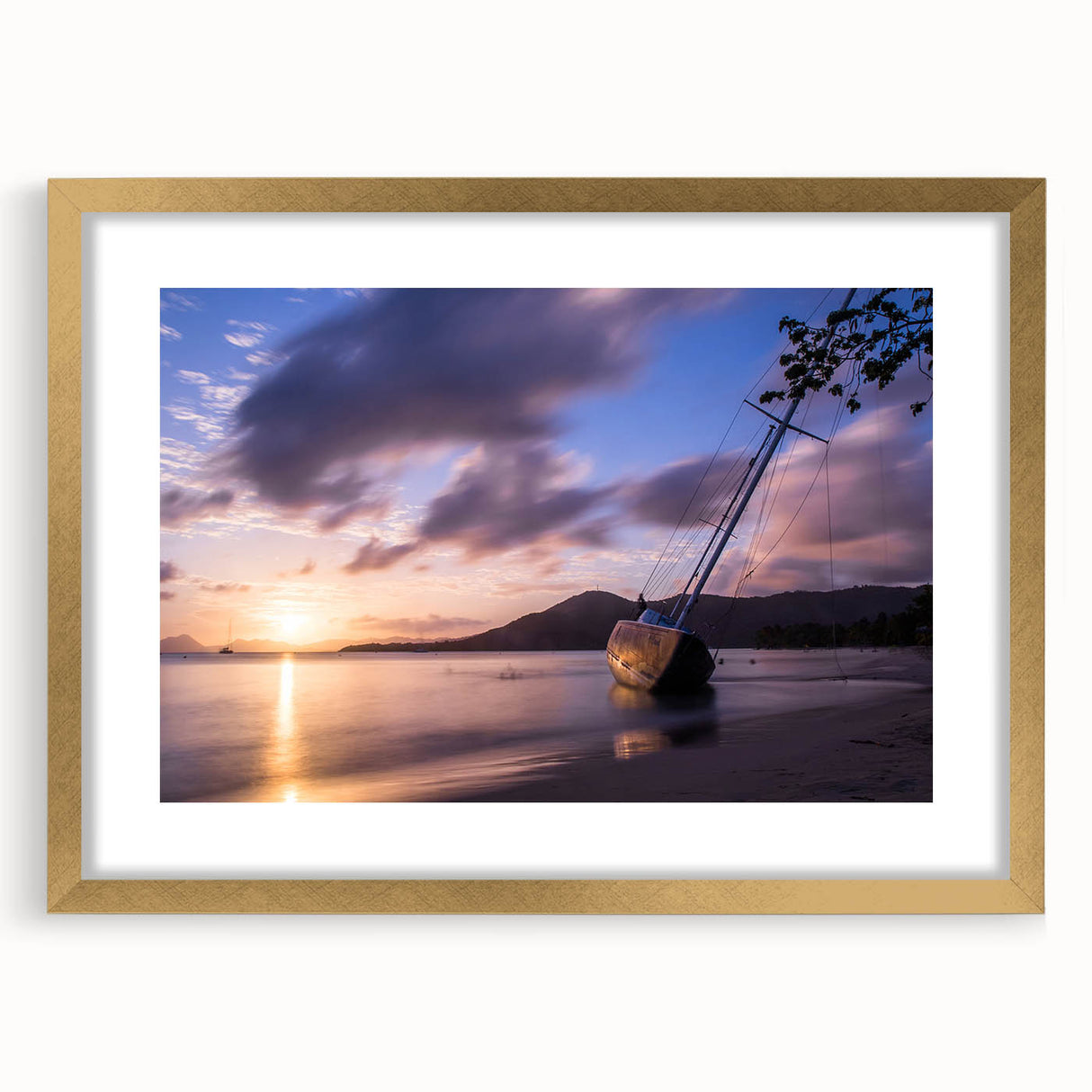 Abstract art print depicting a Caribbean seascape in vibrant blue and green hues, framed in gold.