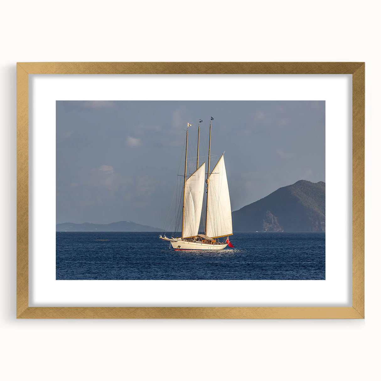 Abstract art print of a Caribbean scene in muted blue and green tones on a framed gold mat, suitable for dining room decor.