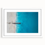 Textured abstract art print of Caribbean scenery in muted blue tones on a framed white mat, ideal for bedroom wall decor.