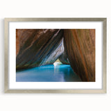 Extra large wall art depicting an abstract Caribbean scenery in textured tones of blue and green, framed in silver.