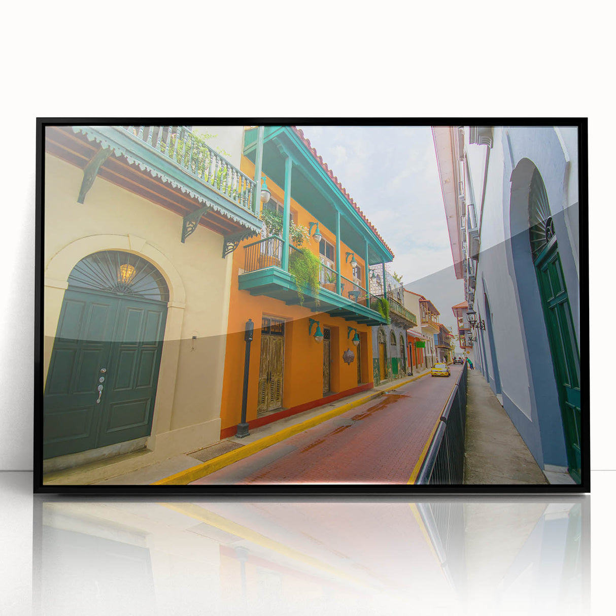 Large abstract wall art depicting a vibrant Central American scenery in a black framed acrylic.