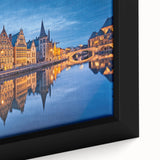 Black wall art featuring a textured, colorful depiction of a European scenery on a large framed canvas.