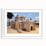 Textured abstract art print of a Cyprus landscape in muted earth tones, framed with a white mat, suitable for bedroom decor.