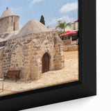 Black wall art featuring a textured, colorful European cityscape on a large framed canvas, ideal for living room decor.