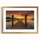 Abstract art print of Cumbria's landscape in muted green and blue tones on a framed gold mat, ideal for dining room decor.