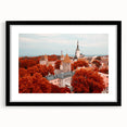 Colorful abstract art print of a European scenery in vibrant hues, framed in black, ideal for living room decor.