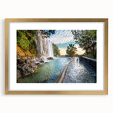 Abstract art print of a European seaside in muted blue and tan colors, framed in gold, suitable for dining room decor.