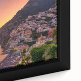 Close-up of a framed canvas depicting the Amalfi Coast in Italy, featuring black textured cliffs and vibrant.