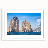 Textured abstract art print of Capri, Italy, in muted earth tones on a framed white mat, suitable for bedroom decor.