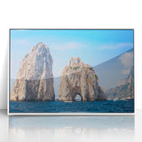 Mid-century modernist art depicting the Capri coastline in muted blue and white tones, acrylic print framed in white.