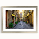 Extra large abstract art print of Florence scenery in muted earth tones on a silver-framed canvas.