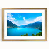 Abstract art print of Lake Como with muted blue and green hues on a framed gold mat, ideal for dining room decor.
