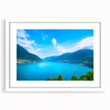 Textured art of Lake Como, featuring abstract water and sky in muted blues and greens, framed in white.