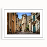 Textured art print of an abstract Sicilian landscape in muted earth tones on a framed white mat, suitable for bedroom decor.