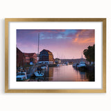 Abstract art print of a European landscape in muted gold and green tones, framed with a gold mat.