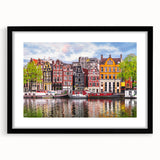 Extra large abstract art print of a colorful European scenery on textured canvas, framed in black.