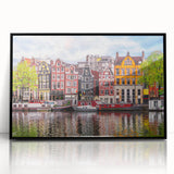 Large abstract wall art depicting a European scenery in muted earth tones, framed in black acrylic.