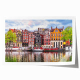 Rolled canvas print of a European scenery with vibrant floral elements in lush green and pink.