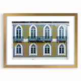 Abstract art print of Lisbon in muted gold and blue tones, framed with a gold mat, suitable for dining room decor.
