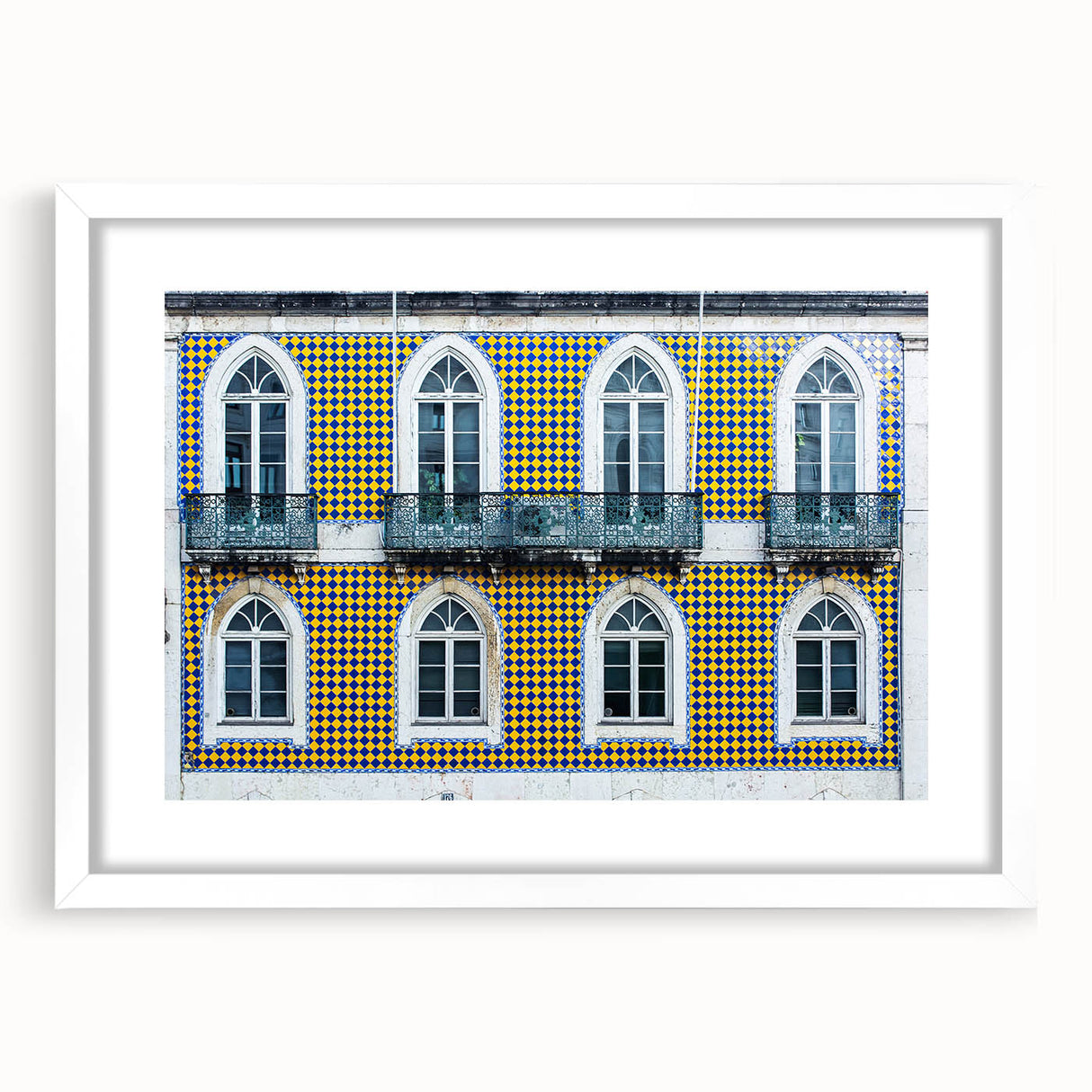 Textured abstract art print of Lisbon scenery in muted earth tones on a framed white mat, suitable for bedroom decor.