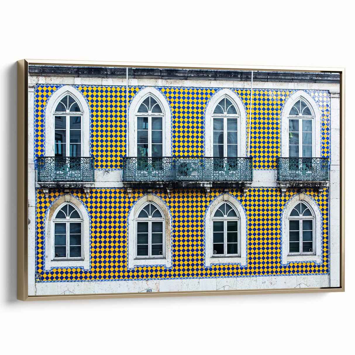 Framed canvas of a vintage Lisbon landscape in muted gold and black tones, ideal for bedroom wall art.