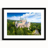 Abstract art print of a colorful European scenery in a black frame, ideal for living room decor.