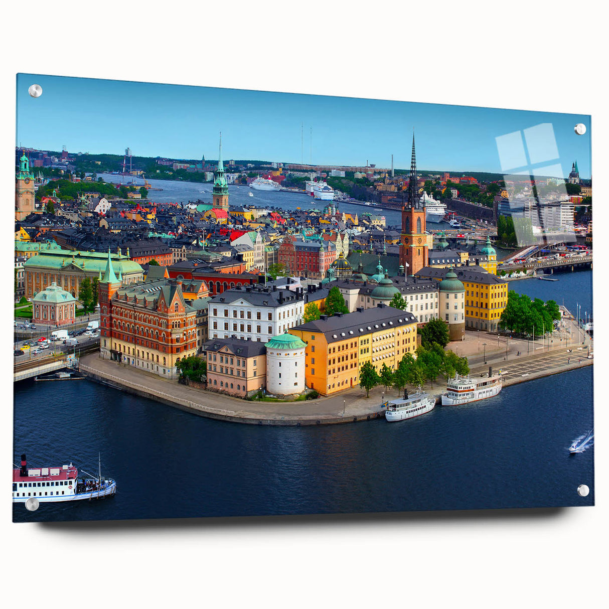 Large abstract wall art of a European scenery in muted blue and green tones on acrylic glass.