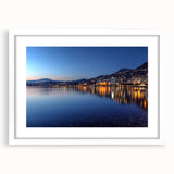 Abstract art print of Geneva scenery in muted blues and grays, framed with a white mat.