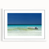 Abstract art print of Cancun scenery in muted blue and green tones on a framed white mat, ideal for dining room decor.
