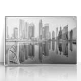 Acrylic print of Dubai skyline in muted gray and white tones, framed in white, ideal for modern art wall decor.