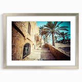 Textured abstract art print of Tel Aviv cityscape in muted earth tones on a silver-framed canvas, suitable for bedroom art.