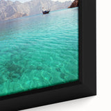 Close-up of a framed canvas featuring a textured black wall art scene of Oman scenery with colorful accents.