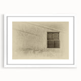 Abstract art print of Qatar scenery in muted earth tones on a framed white mat, suitable for dining room decor.