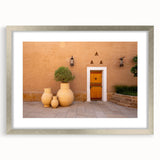 Textured abstract art print of a Middle Eastern landscape in muted earth tones on a framed canvas.