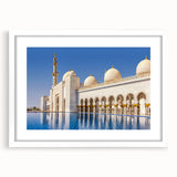 Abstract art print of Abu Dhabi skyline in muted blue and gray tones on a framed white mat.