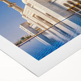 Art deco poster featuring the Abu Dhabi skyline in muted gold and blue tones on rolled canvas.