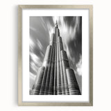 Textured art print featuring an abstract depiction of the Burj Khalifa in gray tones, framed in silver.