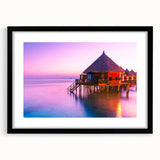 Colorful abstract art print of a textured ocean scene in vibrant blues and greens, framed in black.