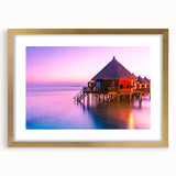 Extra large abstract art print depicting a serene oceanic scene in muted blue and teal tones, framed in gold.