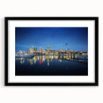 Colorful abstract art print of Auckland scenery in a black frame, ideal for living room wall decor.
