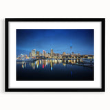 Colorful abstract art print of Auckland scenery in a black frame, ideal for living room wall decor.