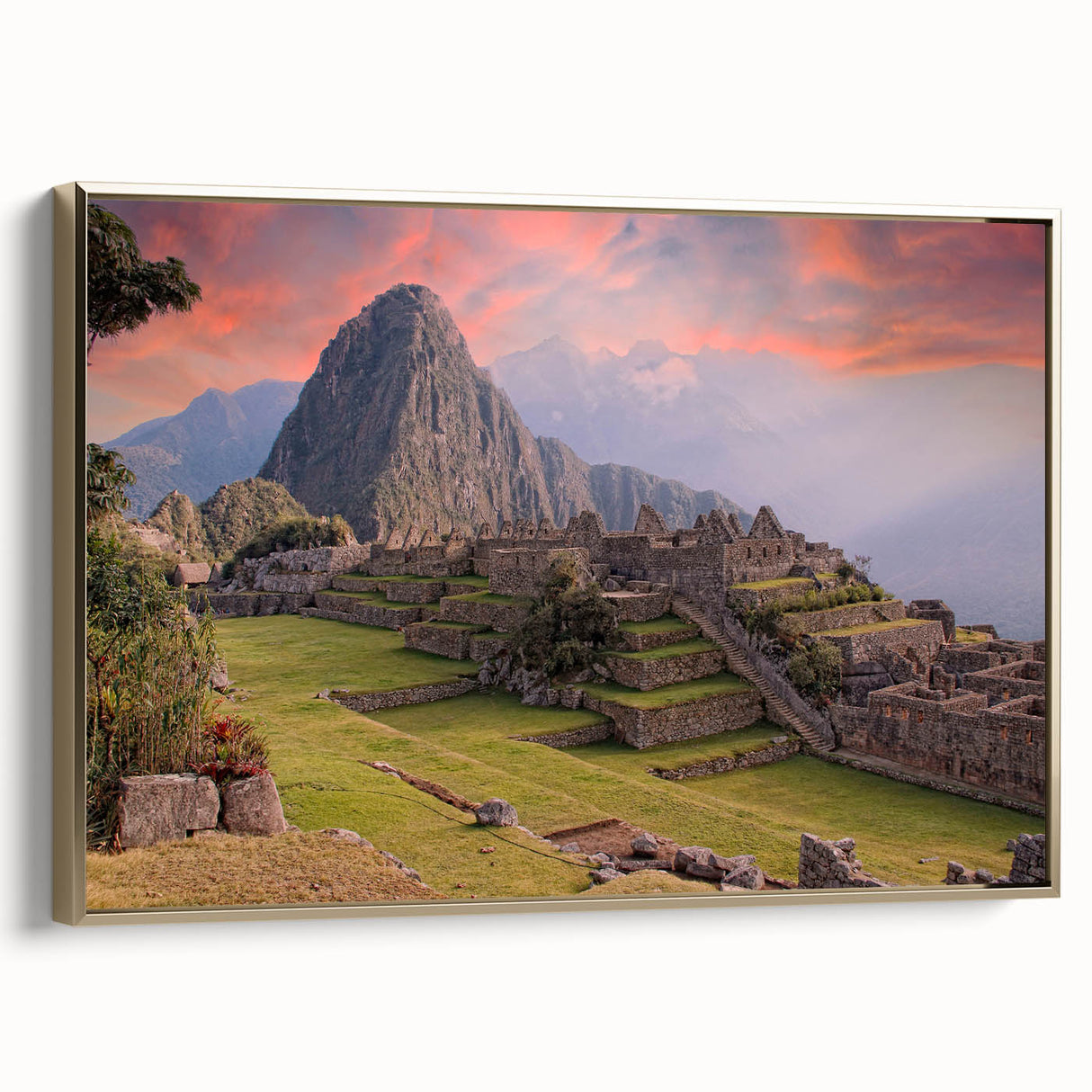 Framed canvas wall art showing a vintage-style landscape painting of Machu Picchu in black and gold tones.
