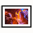 Colorful abstract art print of Arizona's Antelope Canyon in vibrant red and orange tones on a large textured canvas.